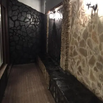 a dark hallway with a stone wall and lights at Cadiz Deluxe Apartment in Cádiz