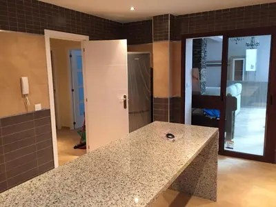 a kitchen with a granite counter top in a room at Cadiz Deluxe Apartment in Cádiz