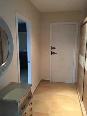 a room with a dresser and a mirror and a door at Cadiz Deluxe Apartment in Cádiz