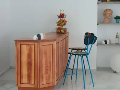 a wooden counter with two blue stools in a room at Hostal La Casa Sanlúcar in Sanlúcar de Barrameda