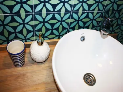 a bathroom with a toilet and a white sink at Hostal La Casa Sanlúcar in Sanlúcar de Barrameda