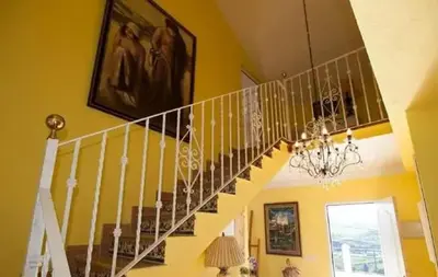 a staircase in a house with a chandelier at Elegant Villa in Algar with Private Pool in Algar