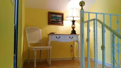 a room with a lamp and a chair and a table at Elegant Villa in Algar with Private Pool in Algar
