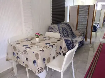 a table and chairs with a table and a couch at Casa Inocencio in El Puerto de Santa María