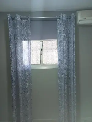 a window with a curtain in a room at Casa Inocencio in El Puerto de Santa María