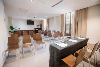a conference room with a long table and chairs at Itaca Jerez by Soho Boutique in Jerez de la Frontera
