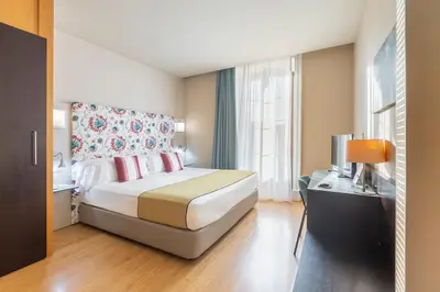 a hotel room with a large bed and a window at Itaca Jerez by Soho Boutique in Jerez de la Frontera