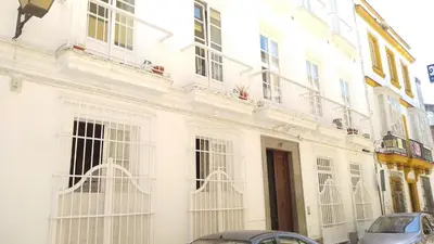 a white building with white windows on a street at Sherryflat Azahar in Jerez de la Frontera