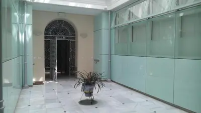 a hallway with a plant in the middle of a building at Sherryflat Azahar in Jerez de la Frontera