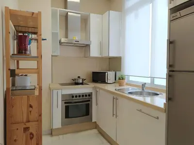 a small kitchen with a sink and a microwave at Sherryflat Azahar in Jerez de la Frontera