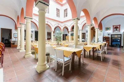 a restaurant with tables and chairs in a building at Hotel Marqués de Torresoto by Vivere Stays in Arcos de la Frontera