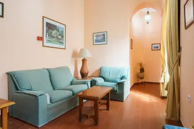 a living room with two blue chairs and a table at Hotel Marqués de Torresoto by Vivere Stays in Arcos de la Frontera