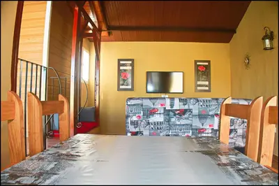a table in a room with a television and a table sidx sidx at Bungalow Curro Pareja 131 in Conil de la Frontera