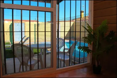a balcony with a view of a table and chairs at Bungalow Curro Pareja 131 in Conil de la Frontera