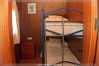 a bunk bed in a room next to a door at Bungalow Curro Pareja 97 in Conil de la Frontera