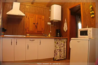 a kitchen with a refrigerator and a microwave at Bungalow Curro Pareja 97 in Conil de la Frontera