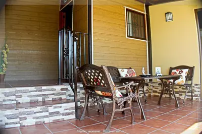 a patio with a table and chairs on a porch at Bungalow Curro Pareja 97 in Conil de la Frontera
