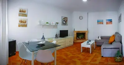 a living room with a couch and a table at Chalet Mari Carmen in Chiclana de la Frontera