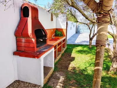 a wood fired pizza oven on the side of a house at Chalet Mari Carmen in Chiclana de la Frontera