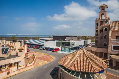 an aerial view of a building with a parking lot at Apartamentos Turísticos Bahía Sur in San Fernando