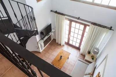 an overhead view of a living room with a spiral staircase at Apartamentos Turísticos Bahía Sur in San Fernando