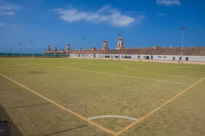 an empty soccer field in front of a building at Apartamentos Turísticos Bahía Sur in San Fernando