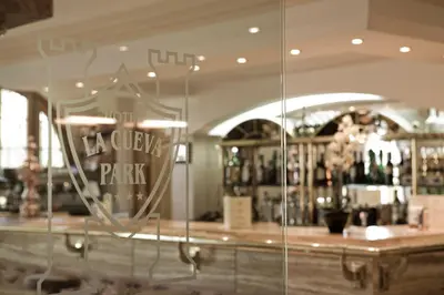a reflection of a bar in the window of a restaurant at La Cueva Park in Jerez de la Frontera
