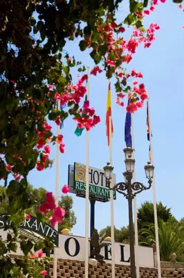 a street sign in front of a fire station with flowers at La Cueva Park in Jerez de la Frontera