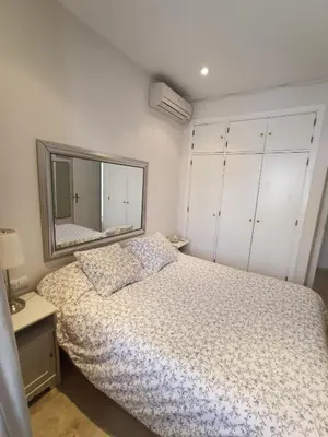 a bedroom with a bed and a large mirror at Azvalia - Ático Larga 112 - Terraza in El Puerto de Santa María