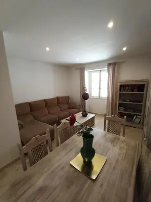 a living room with a table and a couch at Azvalia - Ático Larga 112 - Terraza in El Puerto de Santa María