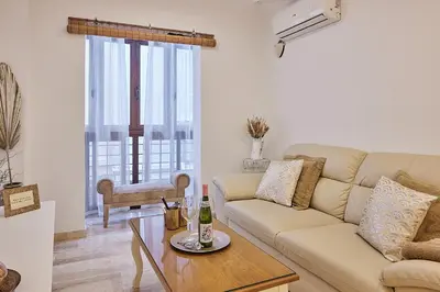 a living room with a couch and a table at Little Arboli Little Apartments in Cádiz