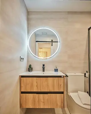 a bathroom with a sink and a mirror at Little Arboli Little Apartments in Cádiz