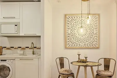 a kitchen with a table and chairs in a kitchen at Little Arboli Little Apartments in Cádiz