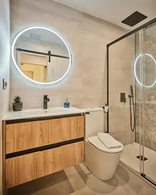 a bathroom with a toilet and a sink and a mirror at Little Arboli Little Apartments in Cádiz