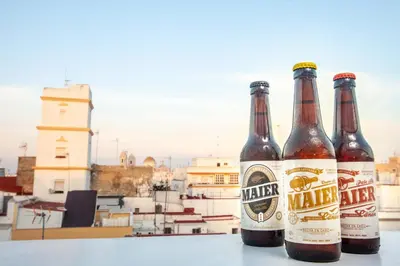 three bottles of beer sitting on a table at Apartamentos Maier in Cádiz