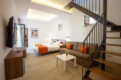 a living room with a bed and a couch at Apartamentos Maier in Cádiz