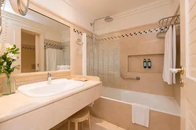 a bathroom with a sink and a bath tub at Hotel Playa Victoria in Cádiz