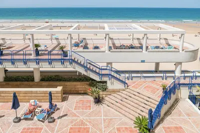 an overhead view of a beach with the ocean at Hotel Playa Victoria in Cádiz