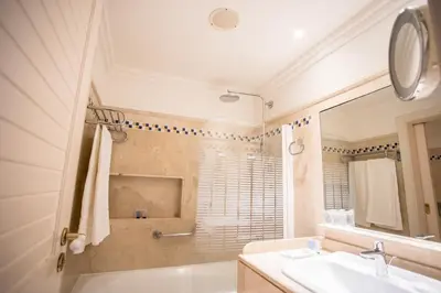 a bathroom with a sink and a shower at Hotel Playa Victoria in Cádiz