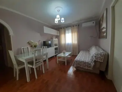a living room with a table and a dining room at Apartamento Zona Norte in Jerez de la Frontera