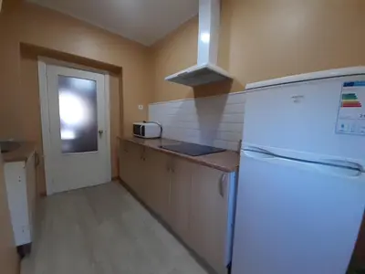 a kitchen with a white refrigerator and a window at Apartamento Zona Norte in Jerez de la Frontera