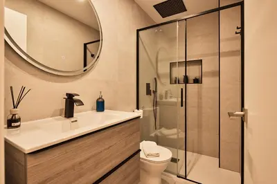 a bathroom with a sink and a toilet and a mirror at Little Sopranis Little Apartments in Cádiz