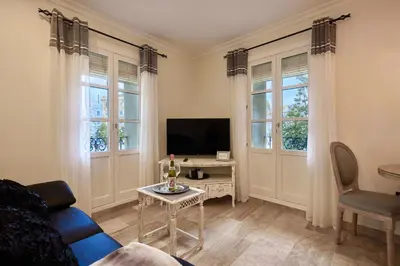 a living room with a couch and a tv at Little Sopranis Little Apartments in Cádiz