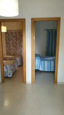 a room with a door to a bedroom with a bed at Hostal las Parcelas in Conil de la Frontera