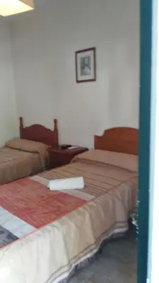 a room with two beds in a room at Hostal las Parcelas in Conil de la Frontera