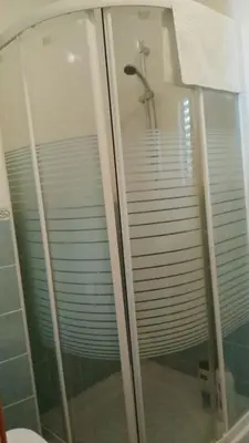 a shower in a bathroom with a glass shower stall at Hostal las Parcelas in Conil de la Frontera