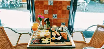 a table with a tray of food and wine glasses at Spanish Galleon Lodge in Cádiz