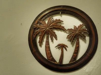 a clock with palm trees on a wall at Spanish Galleon Lodge in Cádiz