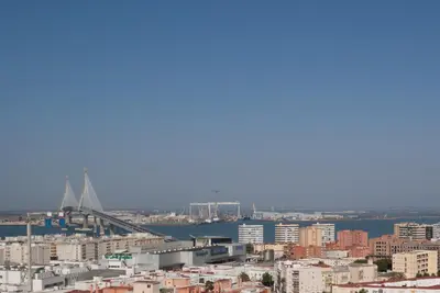 a view of a city with a bridge in the background at Apartment Altavista in Cádiz