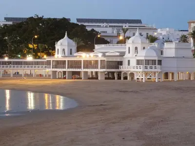 a large white building on the beach at night at Apartment Altavista in Cádiz